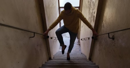 Male dancer in an empty warehouse - Powered by Adobe