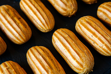  Traditional french eclairs with chocolate. Tasty dessert. Home made cake eclairs  Sweet. Dessert. Pastry filled with cream. Chocolate icing.