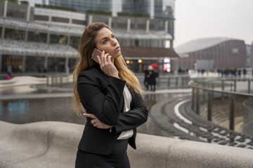 Fototapeta premium Blonde Businesswoman Talking On The Phone