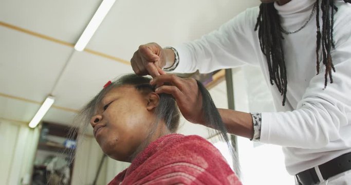 African man adding hair extensions