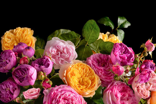 Beautiful bunch of colorful roses flowers on black background