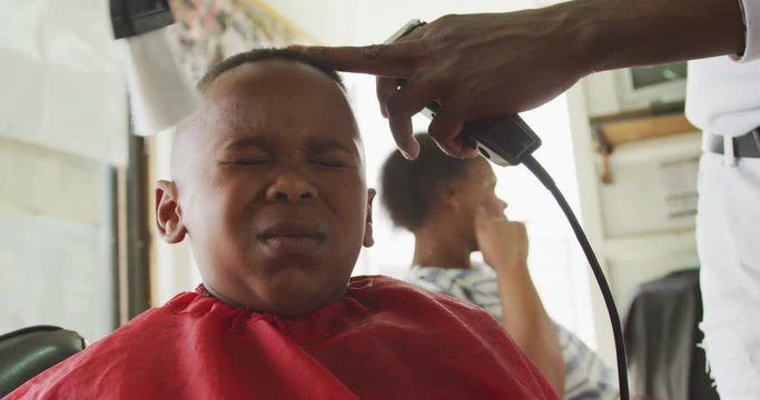 African man cleaning African boy face