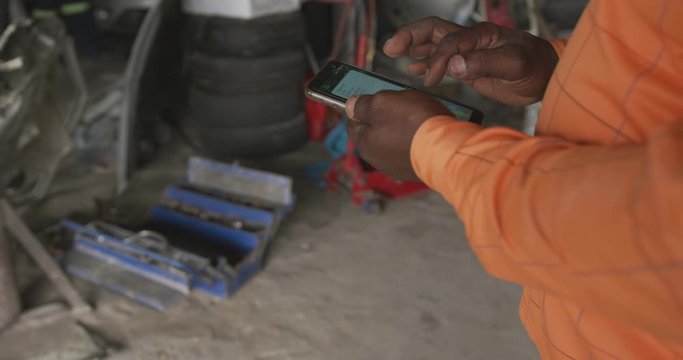 African man using phone at work
