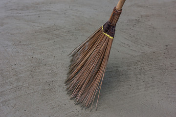 Coconut broom stick on the floor.