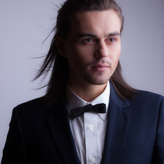 Handsome young elegant man studio portrait.