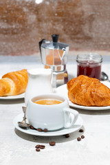 breakfast with espresso and croissants with jam, vertical