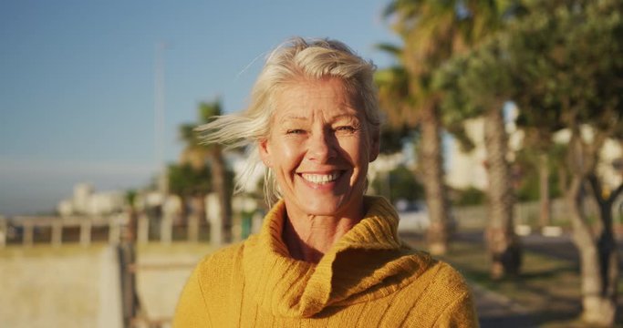 Front view of senior woman alongside beach