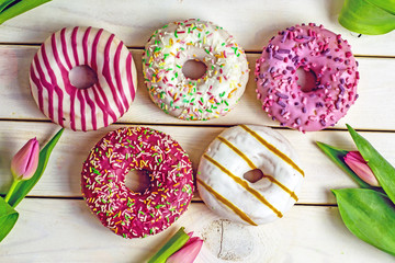 Donuts in colored glaze background