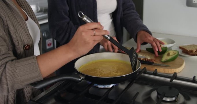 Lesbian couple preparing breakfast in kitchen