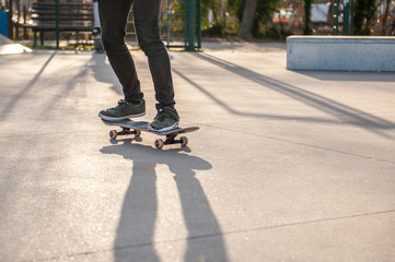 Unrecognizable skateboarder on his board. Photo was taken in backlight