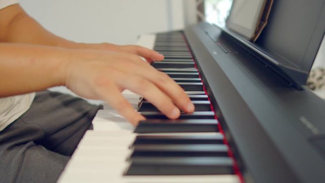 Male Hands Playing Piano. Musical Instrument Playing. Keyboard Instrument
close up shot of male practice playing digital keyboard