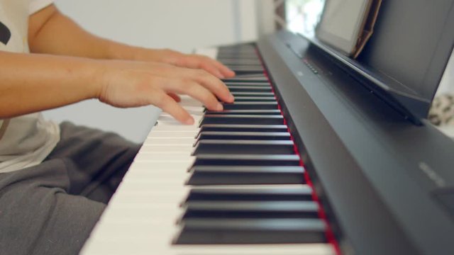 Male Hands Playing Piano. Musical Instrument Playing. Keyboard Instrument
close up shot of male practice playing digital keyboard