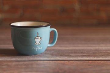 Black coffee in Blue cup on freshly roasted coffee beans background. Top view.