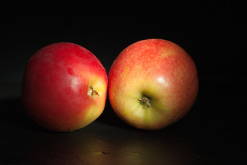 Fototapeta na wymiar Two apples on black. Diet food concept