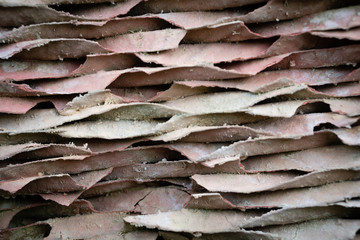 Background with wavy lines of construction material or garbage. Soft lines of light rust and gray on the surface of the building material.