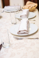 A laid table in a restaurant before a banquet
