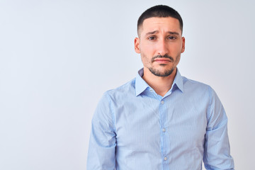 Young handsome business man standing over isolated background depressed and worry for distress, crying angry and afraid. Sad expression.