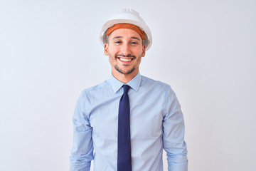 Young business man wearing contractor safety helmet over isolated background with a happy and cool smile on face. Lucky person.