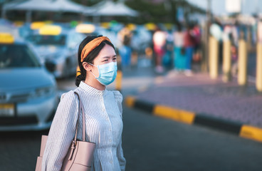 Asian girl wearing face mask at the bus station