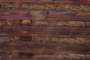old wooden textured background and yellow dry hay, rural element for advertising