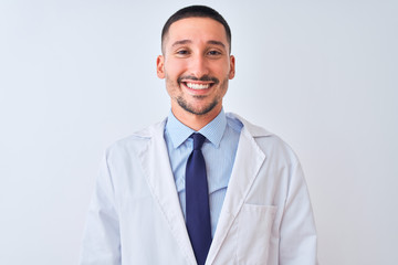 Young doctor man wearing white coat over isolated background with a happy and cool smile on face. Lucky person.
