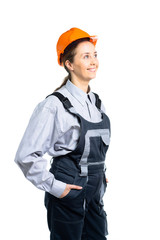 Female builder engineer with helmet on her side, smiling at camera. Isolated