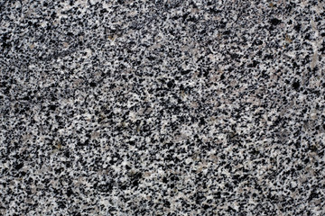 Old stone background from gray granite, for advertising construction services or asphalt texture