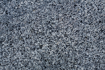 Old stone background from gray granite, for advertising construction services or asphalt texture