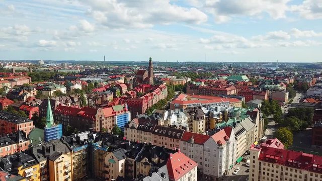 Aerial, drone shot, over buildings and streets in the city of Stockholm, towards the Engelbrektskyrkan church, on a sunny, summer day, in Ostermalm, Sweden