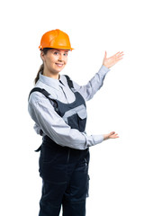 Woman builder shows hand gestures to the side. Isolated