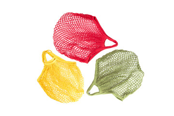 Bright crochet net or mesh eco shopping bags form recycling symbol isolated, creative flat lay for environment friendly zero waste and plastic free ecological lifestyle creative concept. Copy space