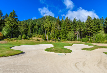 Golf course with gorgeous green and sand bunker