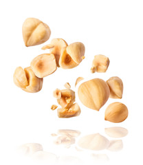 Hazelnuts crushed into pieces, frozen in the air.