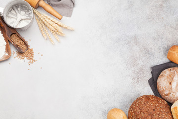Various bread with wheat, flour and cooking utensils