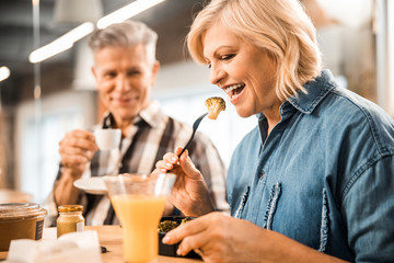 Smiling mature couple is enjoying lunch together