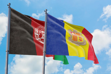 Andorra and Afghanistan flags waving in the wind against white cloudy blue sky together. Diplomacy concept, international relations.