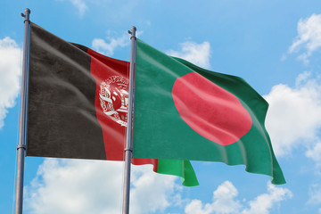 Bangladesh and Afghanistan flags waving in the wind against white cloudy blue sky together. Diplomacy concept, international relations.