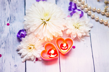 two red burning burning candles hearts flowers bow pearls