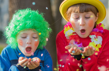 Funny Children girls celebrate carnival smiling and having fun with  colorful confetti