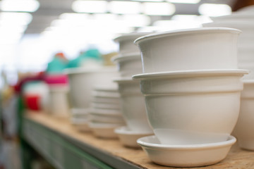 plastic flower pots, pots for indoor plants, garden tools store, shelves with flower pots