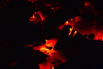 Red and very hot coals in a bonfire.