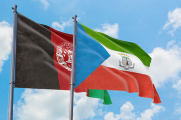 Equatorial Guinea and Afghanistan flags waving in the wind against white cloudy blue sky together. Diplomacy concept, international relations.