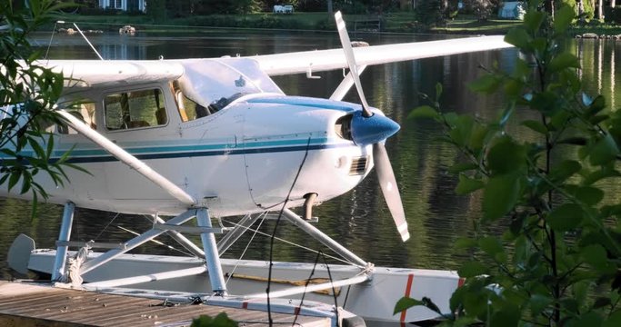 Stunning static shot of a private seaplane docked on a small river