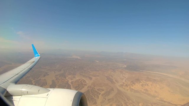 Plane Flying Over Desert After Takeoff from Marsa Alam Airport, Egypt. View From a Plane.