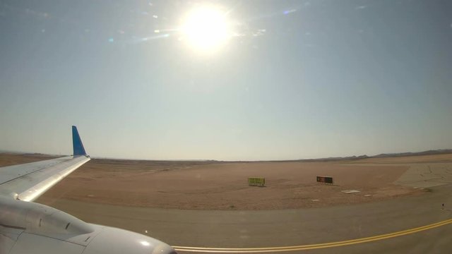 Plane Getting Ready for Takeoff, Taxiing on Runway on Marsa Alam Airport, Egypt. View From a Plane.