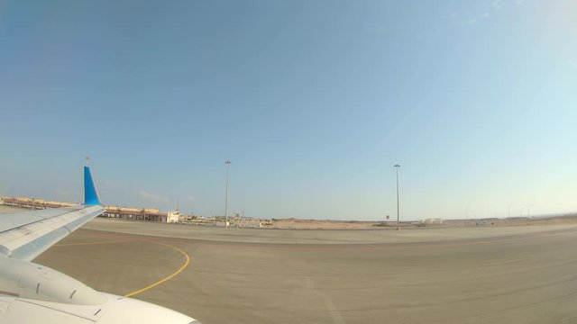 Plane Taxiing on Runway on Marsa Alam Airport, Egypt. Getting Ready for Departure. View From a Plane.