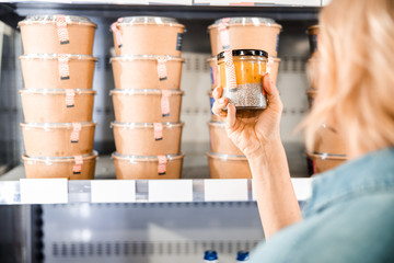 Adult lady is looking on products in store