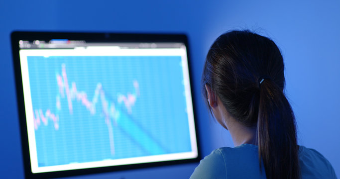 Woman study on stock market data at night