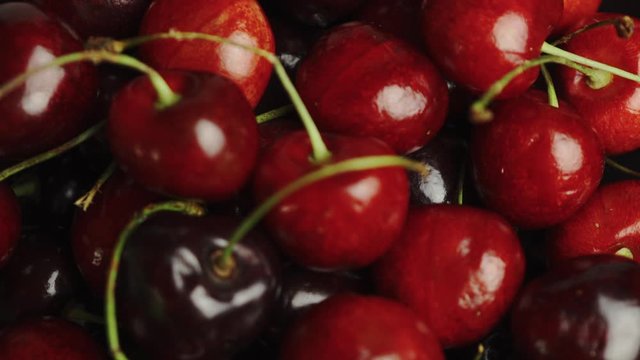 Tracking shot over bowl of cherries.