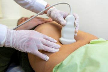Naklejka premium A patient gets an ultrasound scan in a hospital